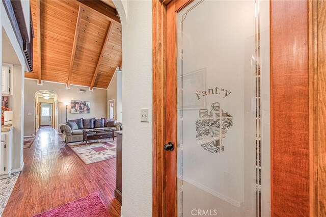 hallway featuring high vaulted ceiling, hardwood / wood-style floors, wood ceiling, and beam ceiling