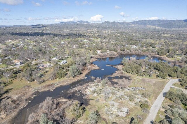 birds eye view of property with a water and mountain view