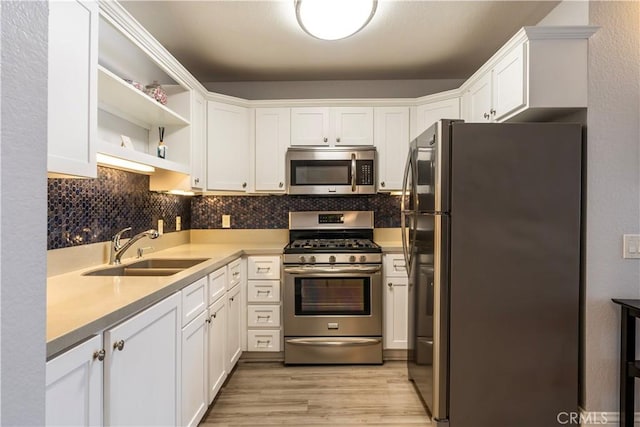 kitchen with white cabinetry, appliances with stainless steel finishes, and sink