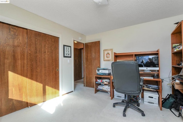 office space featuring light colored carpet and a textured ceiling