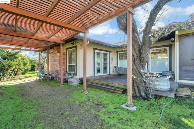 exterior space with a wooden deck, a yard, and a pergola