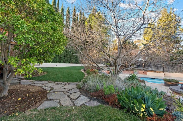 view of yard featuring a fenced in pool