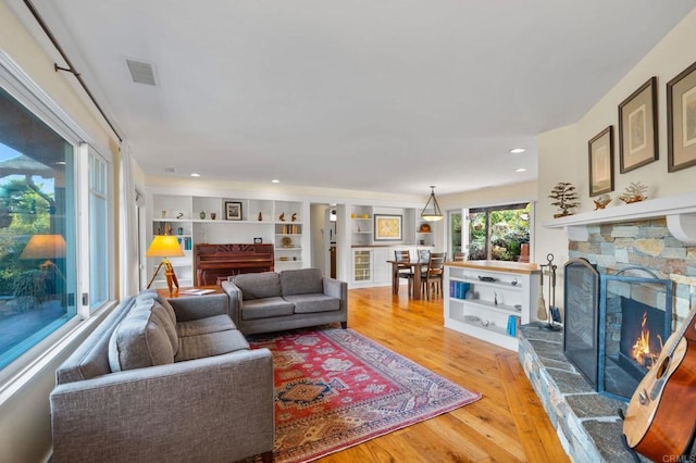 living room with wood-type flooring and a fireplace