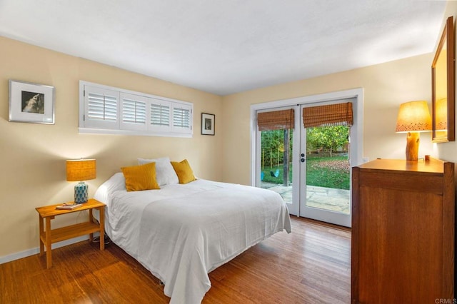 bedroom with hardwood / wood-style flooring and access to outside