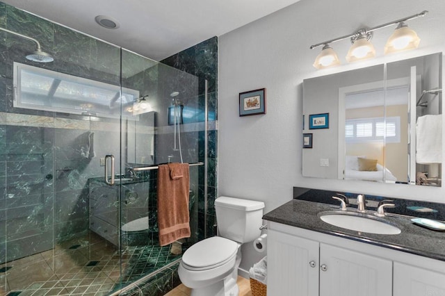 bathroom featuring vanity, toilet, and walk in shower