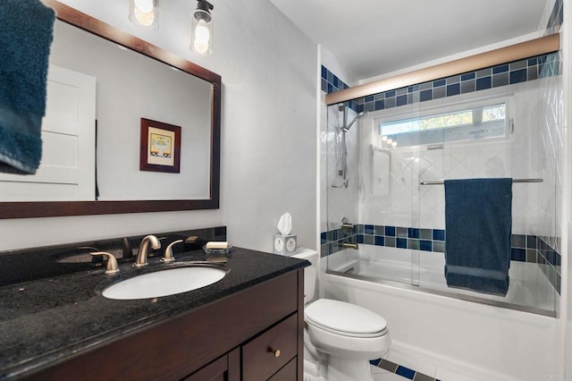 full bathroom with enclosed tub / shower combo, vanity, and toilet