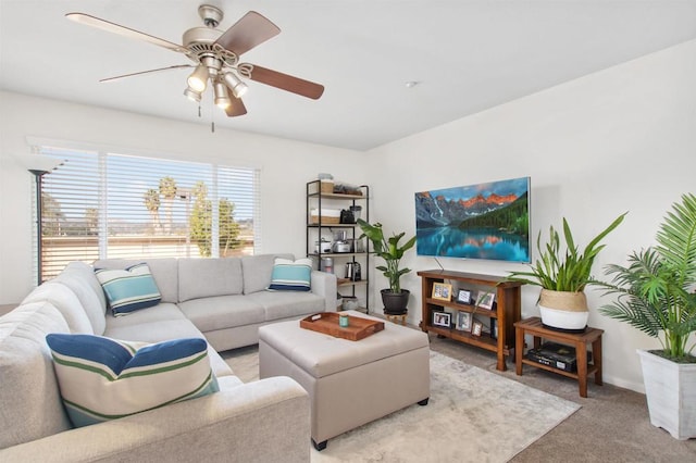 carpeted living room with ceiling fan