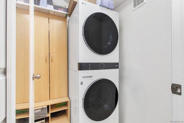 laundry area featuring stacked washer and clothes dryer