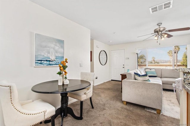 living room with ceiling fan and carpet flooring