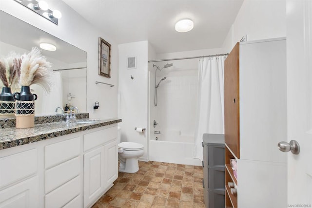 full bathroom featuring shower / bath combo, vanity, and toilet