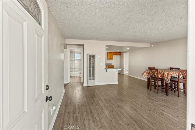 dining room featuring dark hardwood / wood-style floors and a textured ceiling