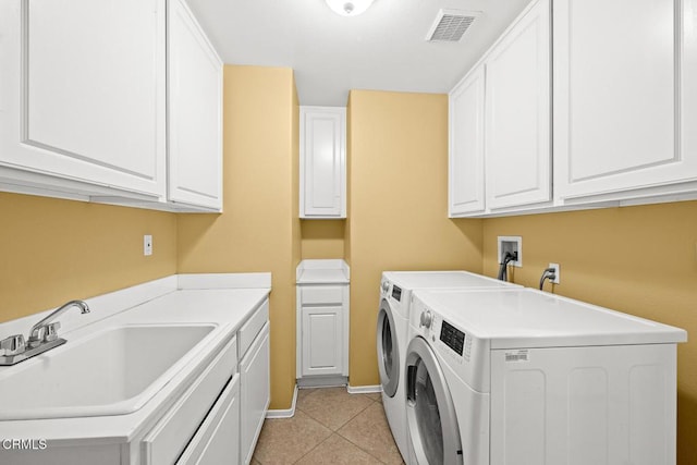 clothes washing area with cabinets, light tile patterned flooring, sink, and independent washer and dryer