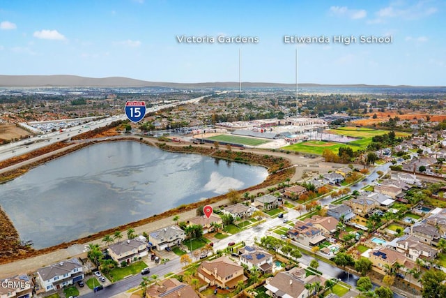 aerial view featuring a water and mountain view