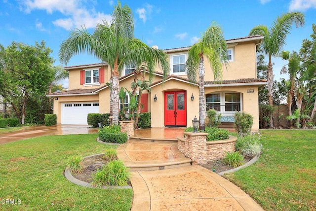 mediterranean / spanish-style house with a garage and a front yard