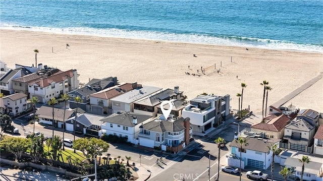 birds eye view of property with a view of the beach and a water view