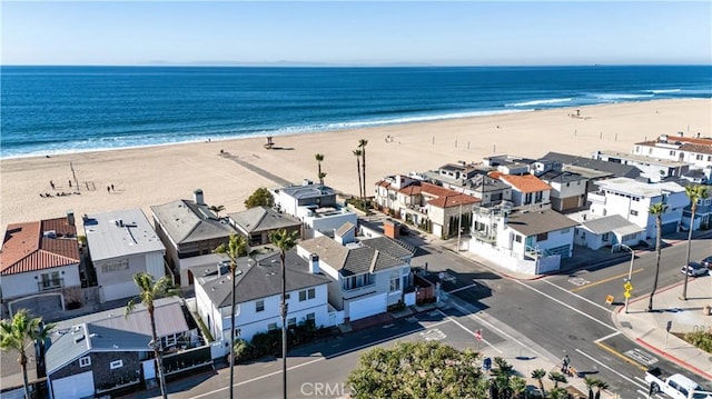 bird's eye view featuring a water view and a beach view