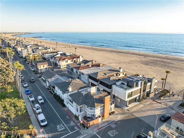 drone / aerial view featuring a water view and a beach view