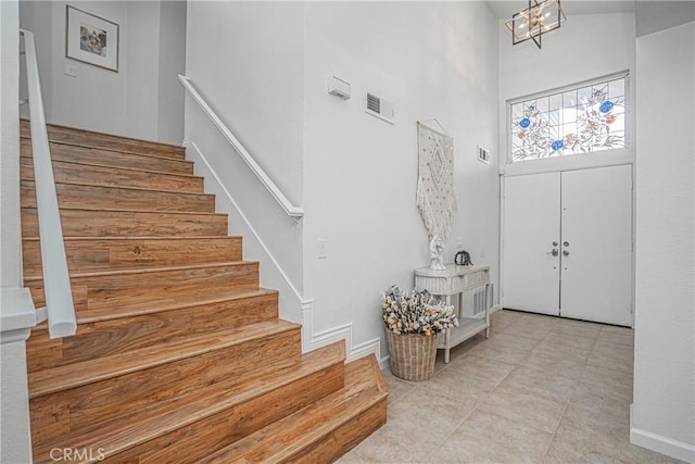 foyer featuring a high ceiling and an inviting chandelier