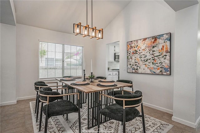 dining area with an inviting chandelier and high vaulted ceiling