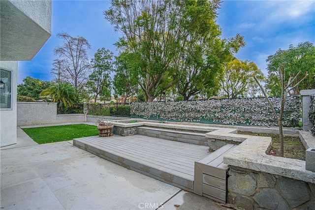 view of patio / terrace with a jacuzzi and a deck