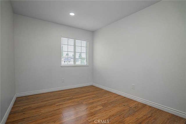 unfurnished room with dark hardwood / wood-style flooring