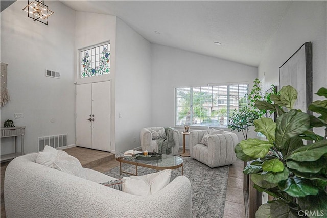 living room featuring plenty of natural light and high vaulted ceiling