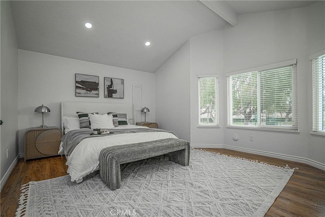 bedroom with lofted ceiling with beams and hardwood / wood-style flooring