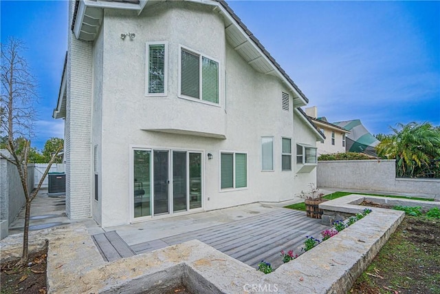 back of house featuring central AC unit