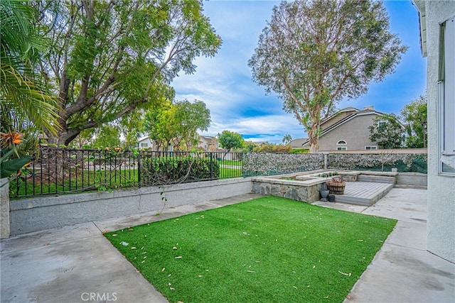 view of yard with a hot tub and a patio area