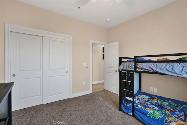 unfurnished bedroom featuring carpet flooring, ceiling fan, and a closet