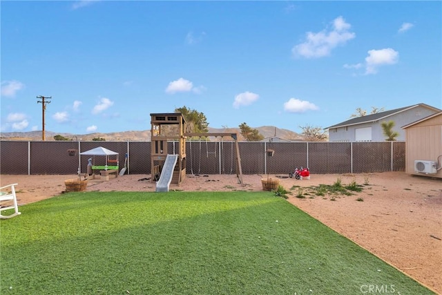 view of yard featuring a playground and ac unit