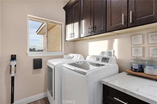 washroom with separate washer and dryer and cabinets