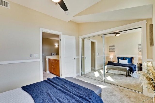 bedroom with ceiling fan, a closet, lofted ceiling, and light carpet