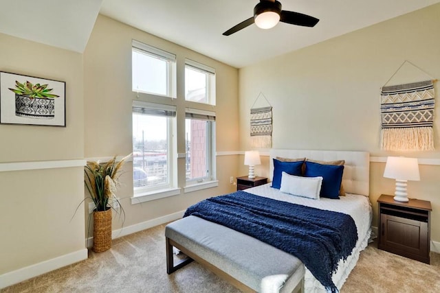 bedroom featuring light colored carpet and ceiling fan