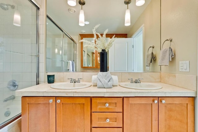 bathroom with bath / shower combo with glass door and vanity