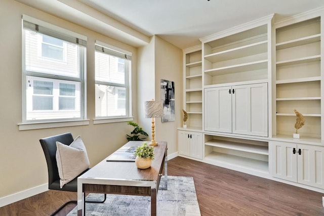 office space featuring dark hardwood / wood-style floors and built in features