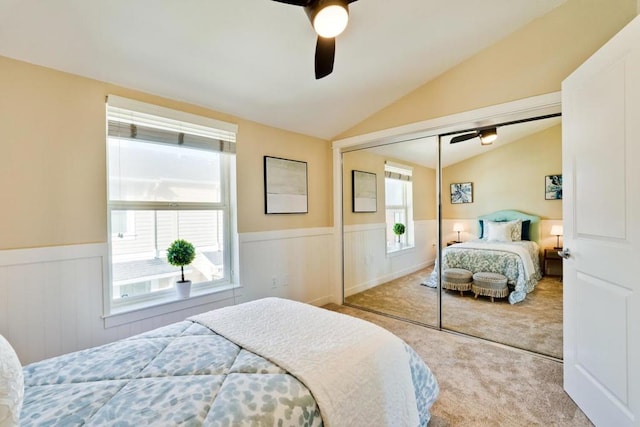 carpeted bedroom with lofted ceiling, ceiling fan, and a closet