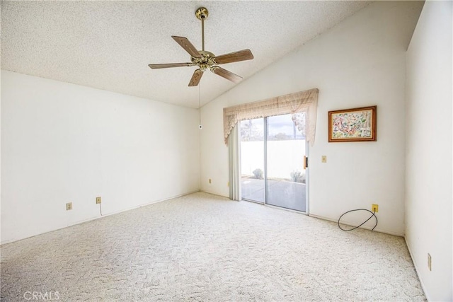 carpeted empty room with ceiling fan, vaulted ceiling, and a textured ceiling