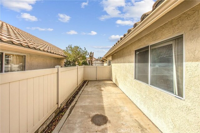 view of side of home with a patio