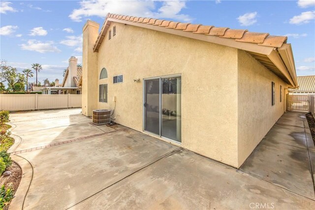 back of property featuring a patio and central AC unit