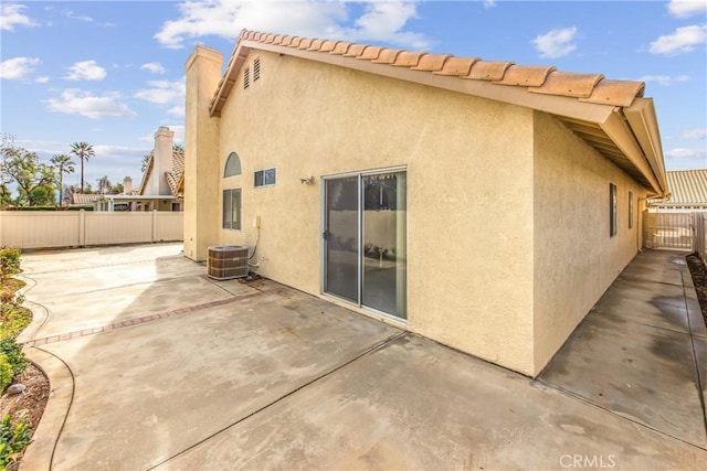 back of property with a fenced backyard, a patio, and stucco siding