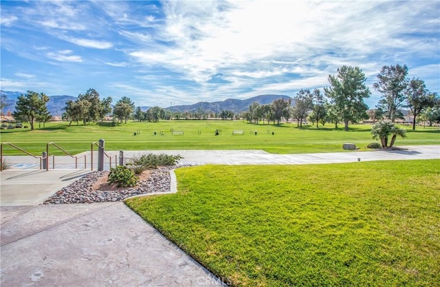 view of home's community featuring a mountain view and a lawn