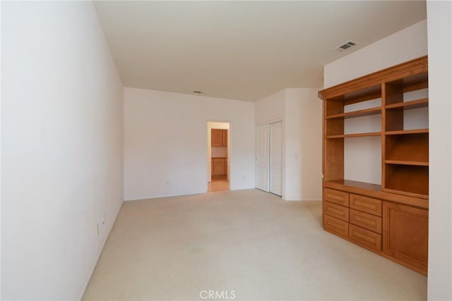 unfurnished living room featuring light carpet