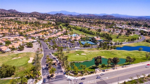 birds eye view of property with a water and mountain view