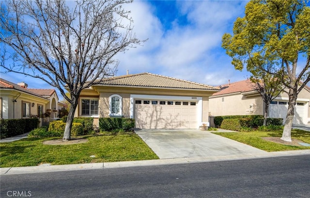 mediterranean / spanish-style home featuring a garage and a front lawn