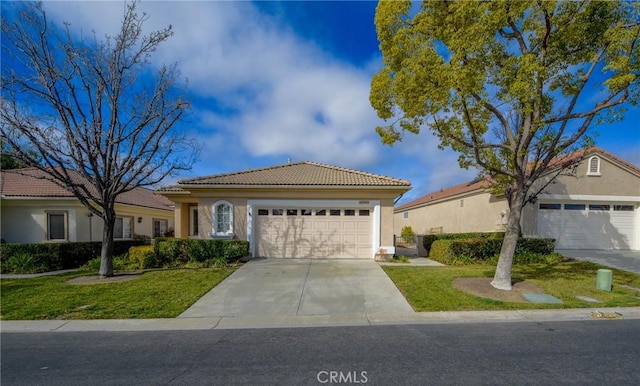 mediterranean / spanish home featuring a garage and a front lawn