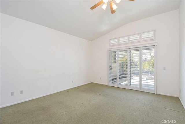 spare room featuring vaulted ceiling, light colored carpet, and ceiling fan