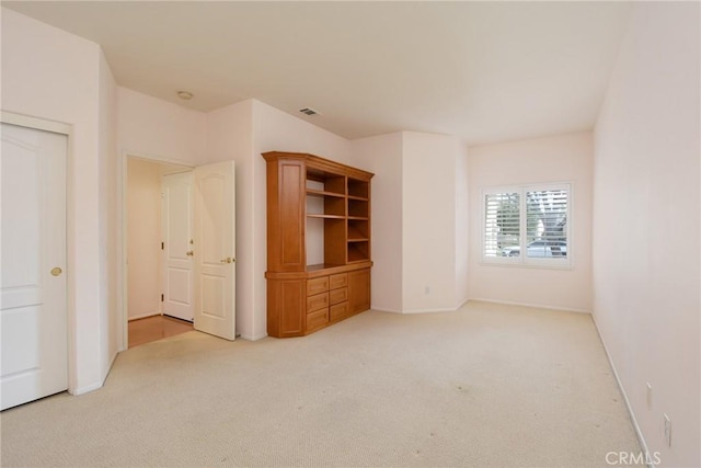 unfurnished bedroom with light colored carpet