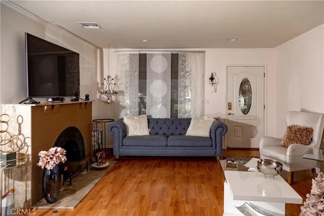 living room with wood-type flooring and ornamental molding