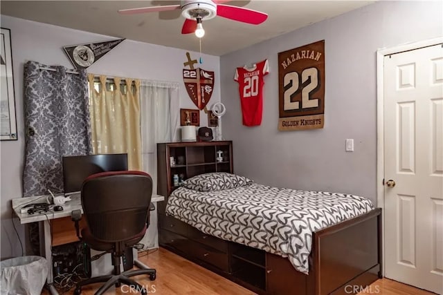 bedroom with wood-type flooring and ceiling fan